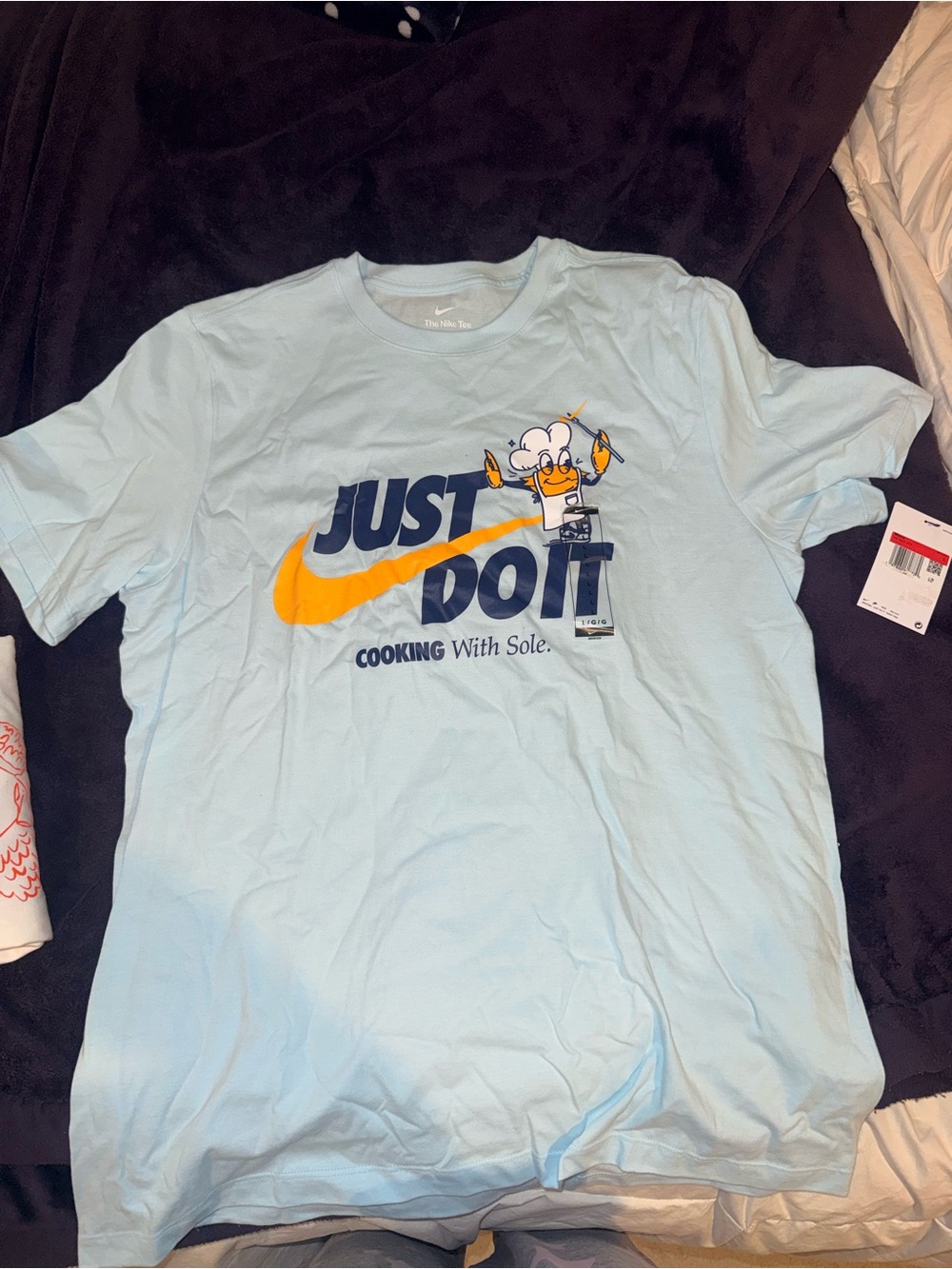 Nike Light Blue Short-Sleeve Graphic Tee with Yellow Swoosh